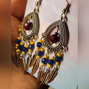 silver earrings with red, blue, yellow beads and feathers
